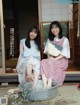 Two young women sitting next to each other in a tub of water.