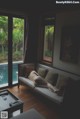 A naked woman laying on a couch in a living room.