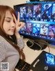 A woman sitting at a desk in front of a computer.