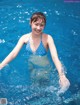 A woman in a blue bikini in a swimming pool.