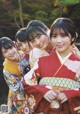 A group of young women in kimonos posing for a picture.